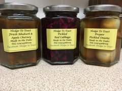 Image may contain: food, text that says "Hedge Το Toast Fresh Rhubarb & Apple Chutney Made in the Dales Tel; 07974568009 Toast Facebook: Hedge to Hedge Το Toast Pickled Red Cabbage Made in the Dales Tel; 07974568009 Facebook: Hedge to Toast Hedge Το Toast Proper Pickled Onions Made in the Dales Tel; 07974568000 Facebook: Hedge to Toast"